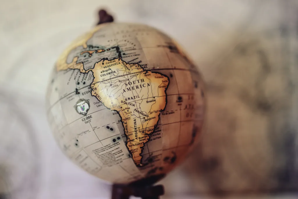 A globe with a map on it focused on South America