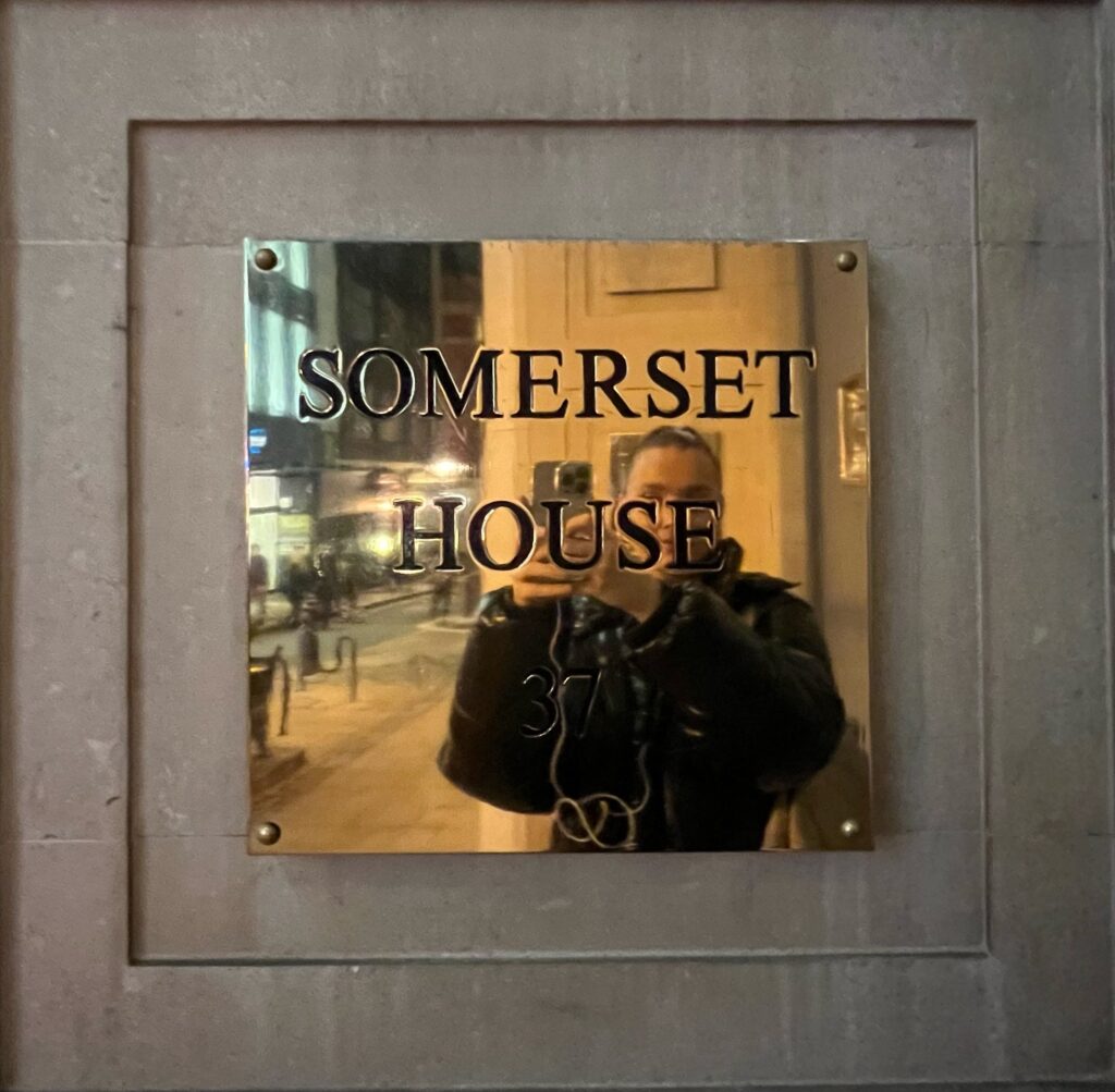 A mirror on a wall with Somerset House