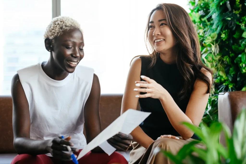 A group of women sitting together reading a report