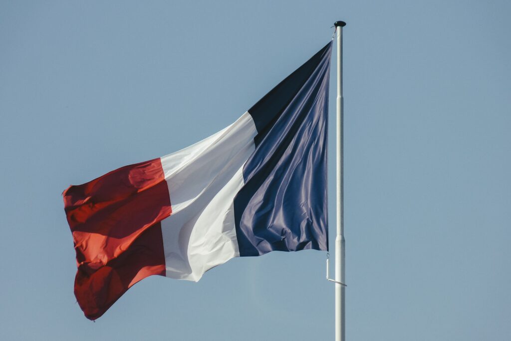 Flag of France waving on blue sky