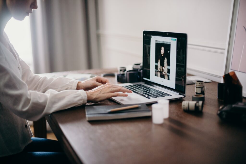 A person using a laptop in a home office