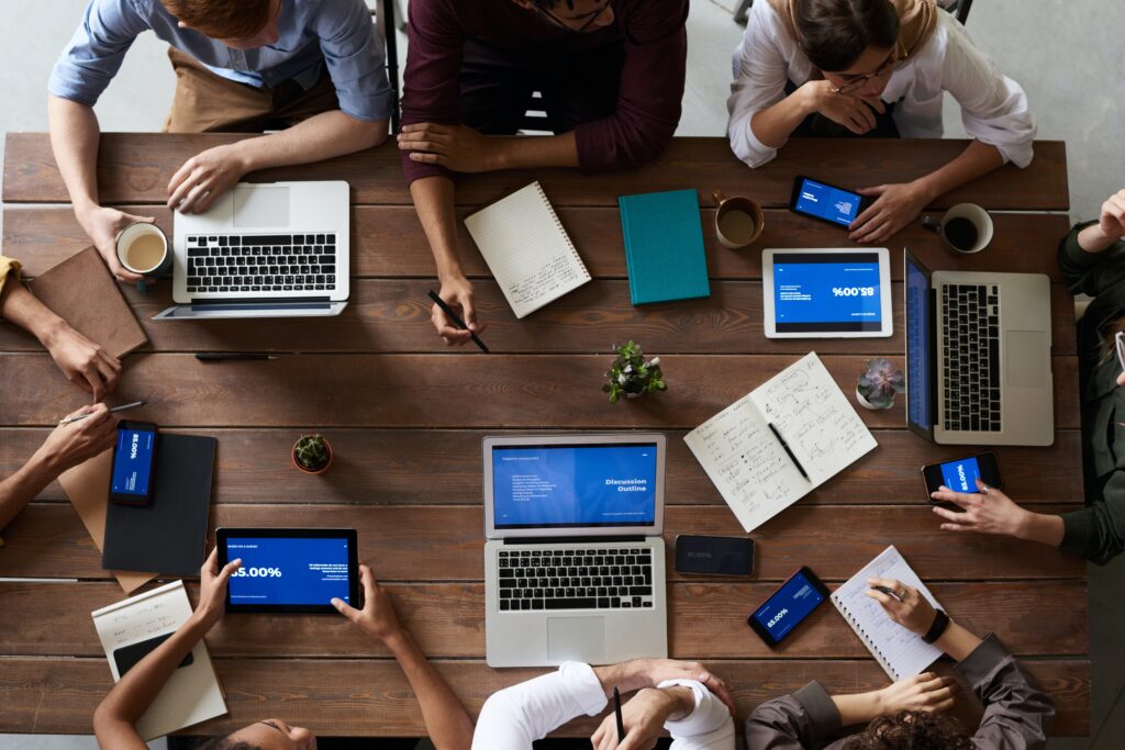 A group of office workers having a meeting using laptops