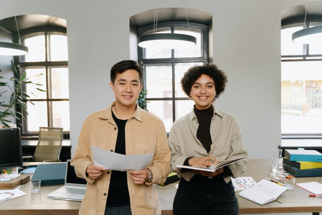 A man and a woman standing in a bright office