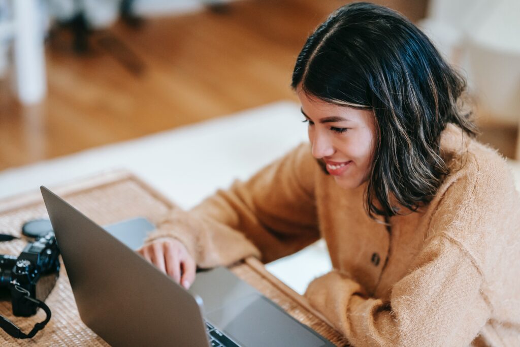 A woman sitting at a table using a laptop