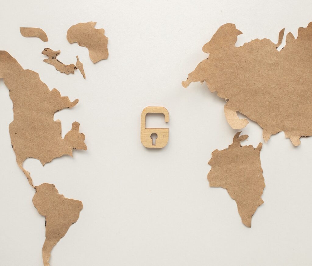 A cut out of cardboard with a lock in the middle of the world