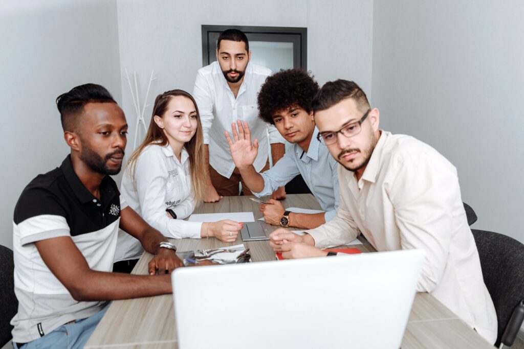 A group of office workers having a video call on a laptop