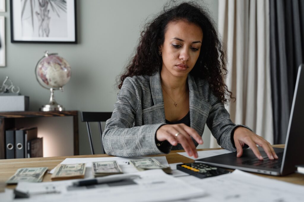 A young lady doing the accounts at her home office