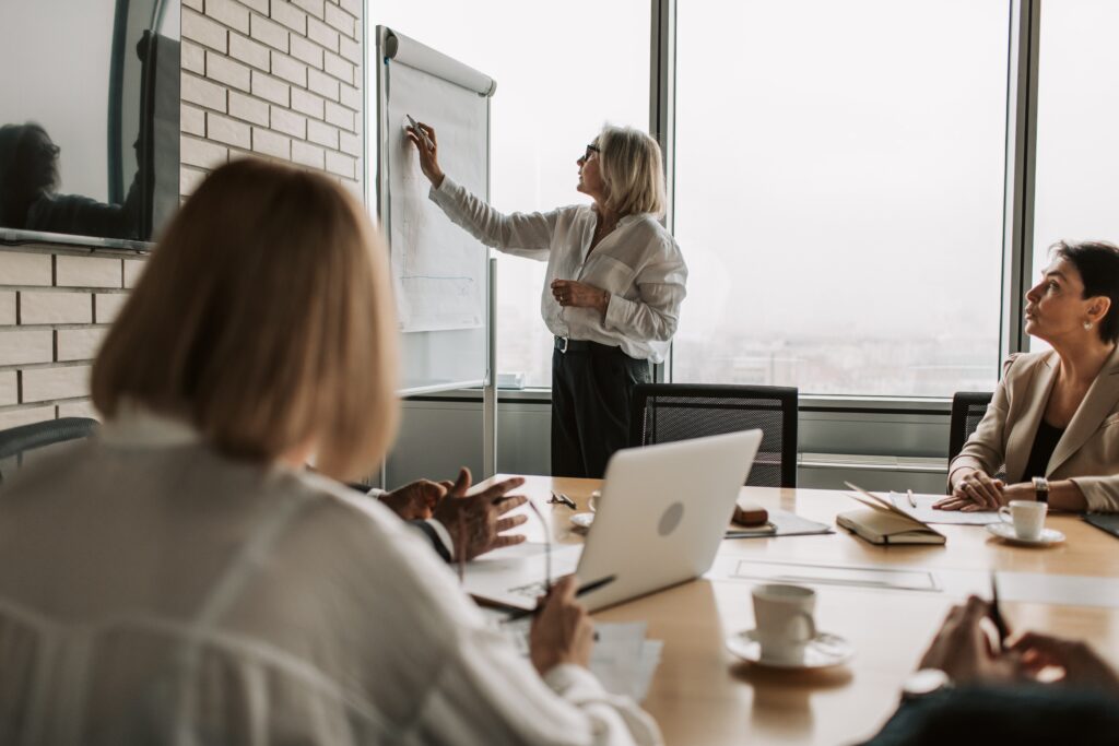 A woman writing on a white board