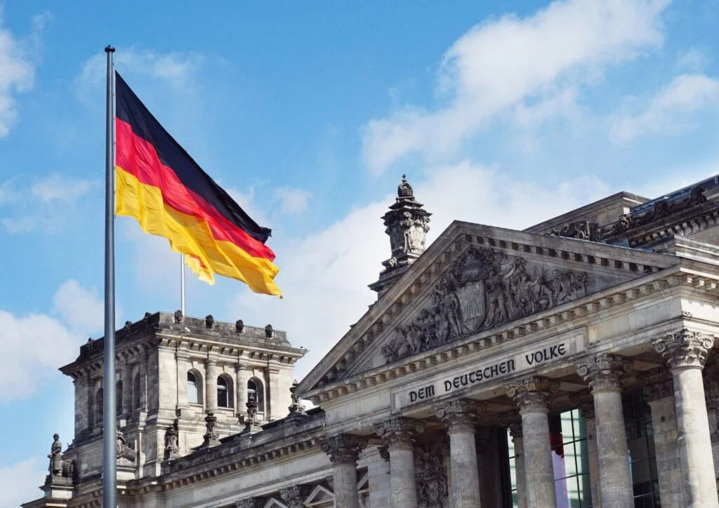 A German flag in front of a historic building