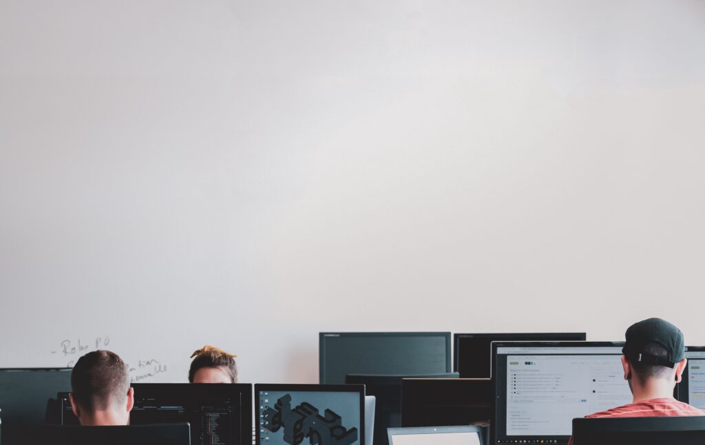 A group of people in a room with computers